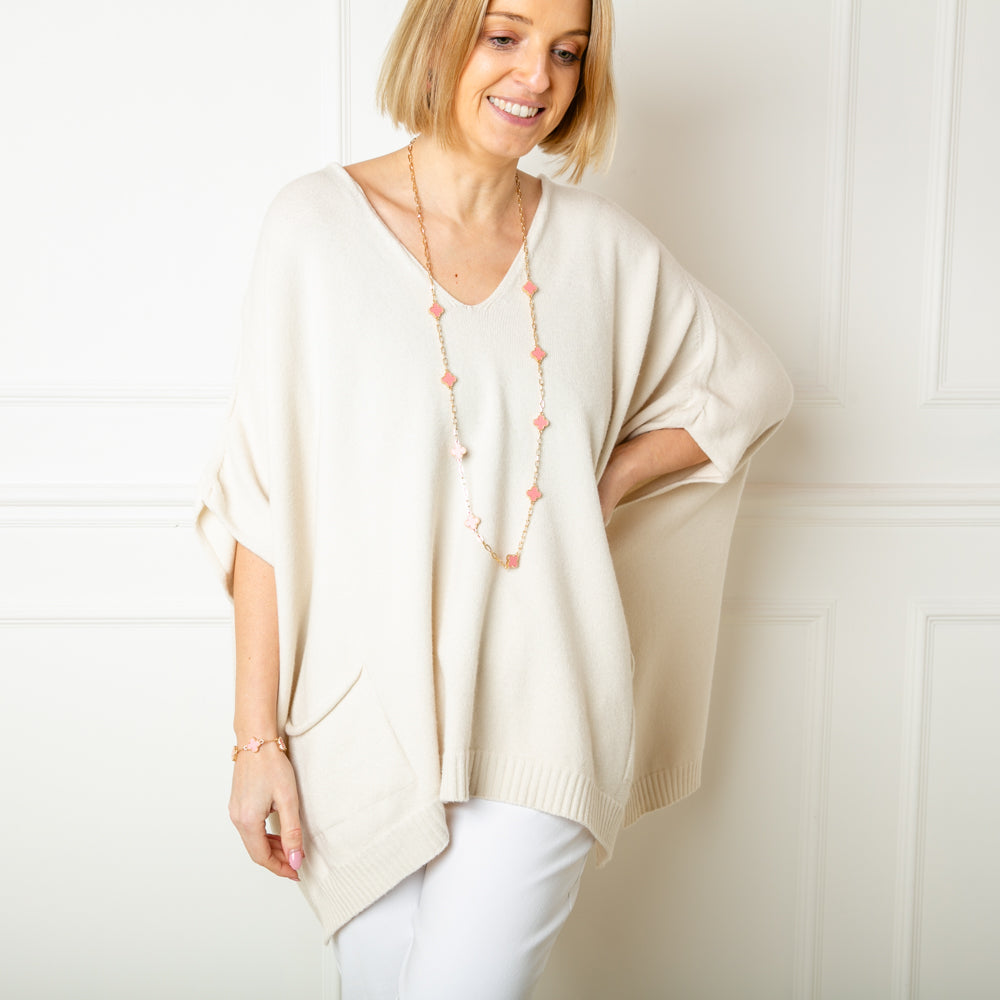 The oatmeal cream V Neck Pocket Poncho jumper with a v neckline and ribbed detailing along the bottom hemline